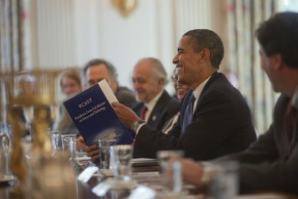 President Barack Obama leads discussion around a conference table