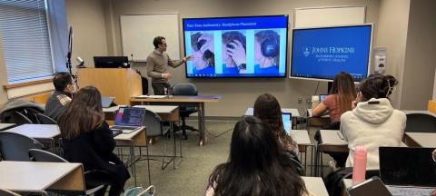 Cochlear Center faculty Nick Reed instructs students